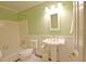 Bathroom featuring a pedestal sink, a tub with tiled walls, and decorative molding at 4495 Glengary Ne Dr, Atlanta, GA 30342