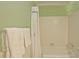 Bathroom tub and shower with neutral and green colored walls and a white shower curtain at 4495 Glengary Ne Dr, Atlanta, GA 30342