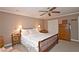 Comfortable bedroom with a ceiling fan, night stands, crown molding and an armoire at 4495 Glengary Ne Dr, Atlanta, GA 30342