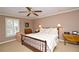Comfortable bedroom featuring a ceiling fan, shutters and a cozy chair with side table at 4495 Glengary Ne Dr, Atlanta, GA 30342