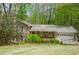 Charming single-Gathering home featuring a manicured front yard, stone accents, and an attached two-car garage at 4495 Glengary Ne Dr, Atlanta, GA 30342