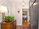 Bright foyer with hardwood floors, a decorative mirror, and a charming table with plants that enhance the entryway at 4495 Glengary Ne Dr, Atlanta, GA 30342