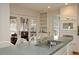 Open kitchen featuring an island with a modern faucet, built-in appliances, and a doorway to a screened porch at 4495 Glengary Ne Dr, Atlanta, GA 30342