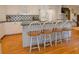 Kitchen with a central island featuring stylish seating, complemented by modern appliances and ample counter space at 4495 Glengary Ne Dr, Atlanta, GA 30342