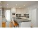 Modern kitchen with stainless steel appliances, a center island with bar stools, and ample cabinet space at 4495 Glengary Ne Dr, Atlanta, GA 30342
