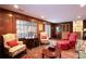 Inviting living room with wood paneling, a decorative fireplace, recessed lights and comfortable armchairs at 4495 Glengary Ne Dr, Atlanta, GA 30342
