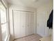 Bright mud room featuring a window, tiled floor, closet, and door with sheer curtain at 4495 Glengary Ne Dr, Atlanta, GA 30342