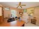 Office with a desk, a sofa, decorations on the walls, and a ceiling fan at 4495 Glengary Ne Dr, Atlanta, GA 30342