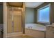 Bathroom featuring a large tub, a glass enclosed shower, and tile flooring at 4975 Skyland Pkwy, Cumming, GA 30028