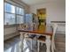 Sunlit dining area featuring an attractive wooden table, seating for six, and a view to the kitchen at 4975 Skyland Pkwy, Cumming, GA 30028