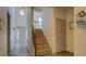 Inviting home entryway with staircase, light fixture, and wood-look flooring at 4975 Skyland Pkwy, Cumming, GA 30028