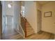 Inviting home entryway with staircase, light fixture, and wood-look flooring at 4975 Skyland Pkwy, Cumming, GA 30028