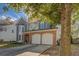 Charming two-story home with a well-manicured lawn and attached two-car garage at 4975 Skyland Pkwy, Cumming, GA 30028