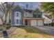 Charming two-story home with a well-manicured lawn and attached two-car garage at 4975 Skyland Pkwy, Cumming, GA 30028
