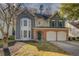 Charming two-story home with a well-manicured lawn and attached two-car garage at 4975 Skyland Pkwy, Cumming, GA 30028