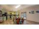 Open kitchen and dining area with light green cabinets, wood flooring, and patio doors at 4975 Skyland Pkwy, Cumming, GA 30028