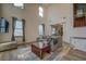 Light-filled living room boasts vaulted ceilings and stylish neutral decor and an adjacent dining area at 4975 Skyland Pkwy, Cumming, GA 30028