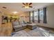 Bright living room with stylish couch, ceiling fan, and view of the backyard at 4975 Skyland Pkwy, Cumming, GA 30028