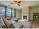 Cozy living room with fireplace, large windows, and neutral decor at 4975 Skyland Pkwy, Cumming, GA 30028