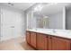 Bathroom vanity with dual sinks, large mirror, and shower with glass door at 5669 Cobblestone Creek Pl # 12, Mableton, GA 30126