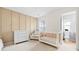 Cozy bedroom featuring a crib, dresser, chair, and ensuite bathroom at 5669 Cobblestone Creek Pl # 12, Mableton, GA 30126