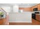 Open kitchen features stainless steel appliances, wooden cabinets and a breakfast bar at 5669 Cobblestone Creek Pl # 12, Mableton, GA 30126