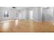Spacious living room with light wood floors, white walls, and multiple entrances at 5669 Cobblestone Creek Pl # 12, Mableton, GA 30126