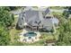 Expansive property featuring a luxurious pool area, landscaped grounds, and a beautifully designed home at 211 Meritage Dr, Alpharetta, GA 30022