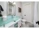 Bright bathroom features a sleek glass countertop, modern fixtures, and white cabinets, creating a clean and stylish space at 211 Meritage Dr, Alpharetta, GA 30022