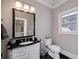 Bathroom features classic vanity with a granite countertop, a decorative mirror and traditional fixtures at 211 Meritage Dr, Alpharetta, GA 30022