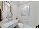 This powder bathroom boasts a marble countertop, modern faucet, and stylish mirror that enhances this space at 211 Meritage Dr, Alpharetta, GA 30022