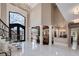 Grand foyer with soaring ceilings, ornate staircase, and exquisite chandelier, making a stunning entrance at 211 Meritage Dr, Alpharetta, GA 30022