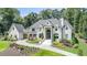 Stately brick home with manicured landscaping, circular driveway, and grand entrance, exuding curb appeal at 211 Meritage Dr, Alpharetta, GA 30022