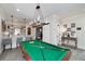 Game room features a pool table, bar area, and stylish lighting, perfect for entertaining guests or relaxing at home at 211 Meritage Dr, Alpharetta, GA 30022