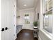 This hallway features a seating area with storage underneath, natural light from a window and outdoor access at 211 Meritage Dr, Alpharetta, GA 30022