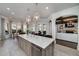 Open kitchen with marble island, granite countertops, stainless appliances, and open view to living room at 211 Meritage Dr, Alpharetta, GA 30022