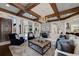 Elegant living room featuring coffered ceiling, fireplace, and plush seating with ample natural light at 211 Meritage Dr, Alpharetta, GA 30022