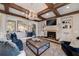 Elegant living room featuring coffered ceiling, fireplace, and plush seating with ample natural light at 211 Meritage Dr, Alpharetta, GA 30022