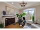 Bright home office with fireplace, large window, and modern desk, offering a productive workspace at 211 Meritage Dr, Alpharetta, GA 30022