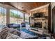 Inviting outdoor patio with stone fireplace, mounted TV, and comfortable seating, perfect for relaxation at 211 Meritage Dr, Alpharetta, GA 30022