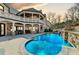 Inviting pool area with a waterfall feature, slide, and covered patio area at 211 Meritage Dr, Alpharetta, GA 30022