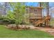 Exterior view of a backyard with a patio, deck, and mature trees at 2320 Starr Lake Nw Dr, Acworth, GA 30101