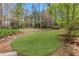 Landscaped backyard featuring a stone retaining wall at 2320 Starr Lake Nw Dr, Acworth, GA 30101