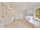 Bathroom with white vanity, tiled floor, glass shower and jacuzzi tub with wooded view at 2320 Starr Lake Nw Dr, Acworth, GA 30101