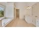 Bathroom featuring jacuzzi tub with a wooded view, access to walk in closet and a white vanity at 2320 Starr Lake Nw Dr, Acworth, GA 30101