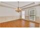 Bright dining room featuring hardwood floors, a decorative chandelier, and large windows at 2320 Starr Lake Nw Dr, Acworth, GA 30101