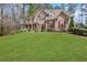 Inviting two-story home with red shutters, lush green lawn, and a classic front porch at 2320 Starr Lake Nw Dr, Acworth, GA 30101