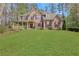 Charming two-story home with a well-manicured lawn and a welcoming front porch with decorative red shutters at 2320 Starr Lake Nw Dr, Acworth, GA 30101
