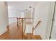 Upstairs hallway featuring hardwood floors and white wainscotting with natural light throughout at 2320 Starr Lake Nw Dr, Acworth, GA 30101