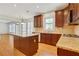 Bright kitchen featuring an island with granite countertops, wood cabinets, and stainless steel appliances at 2320 Starr Lake Nw Dr, Acworth, GA 30101